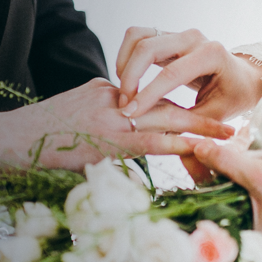 Bridge putting ring on groom